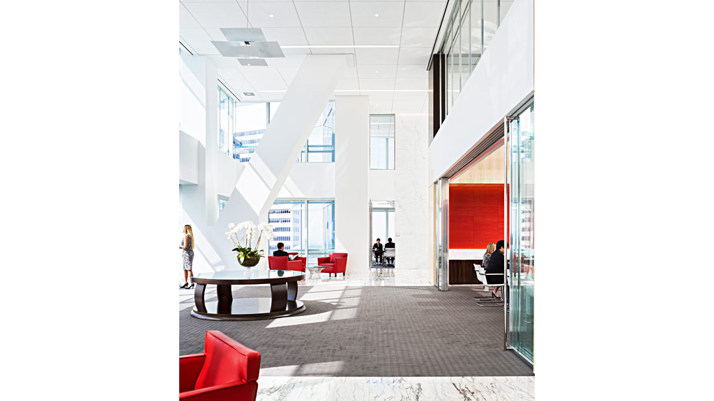 A large room with a table and chairs and a large white ceiling.