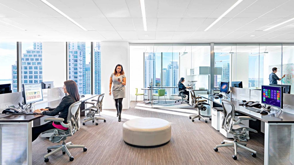 A person standing in front of a room with many computers.