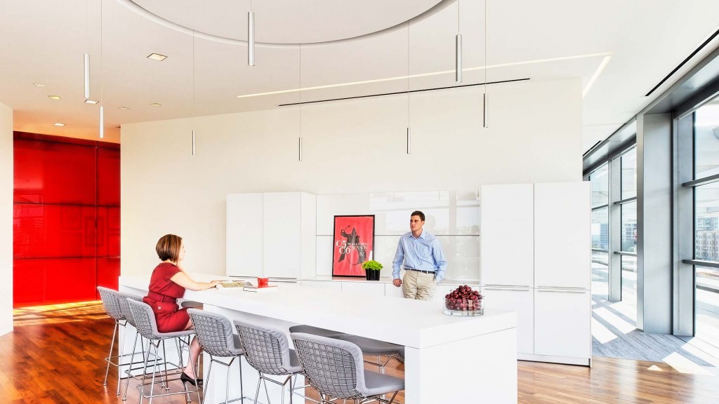 A man and a woman in a kitchen.
