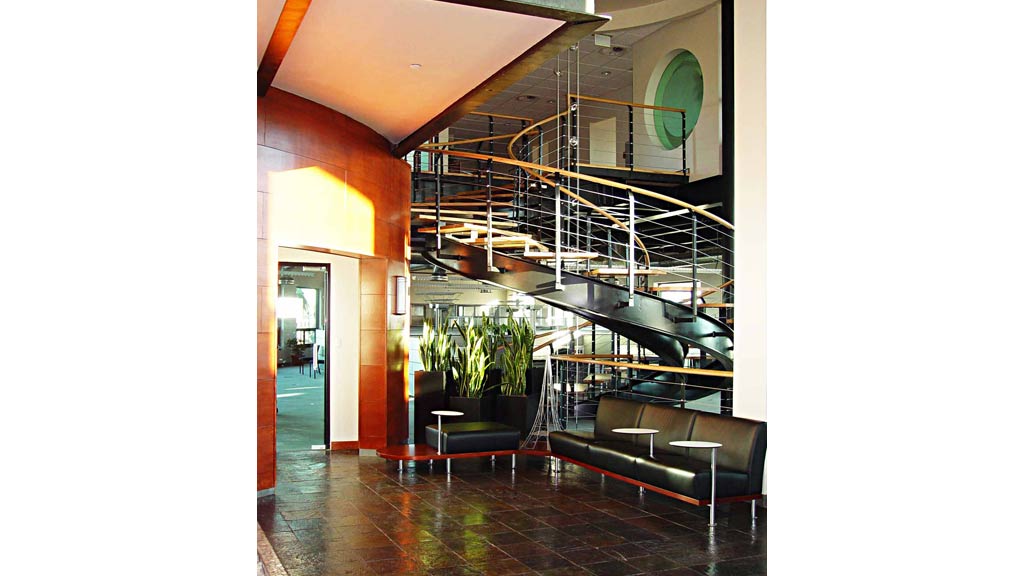 A room with a glass wall and a staircase.