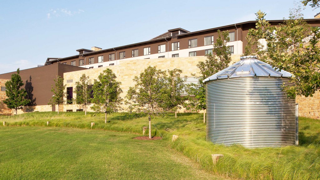 A large building with a large green lawn.
