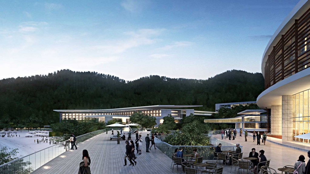 A group of people walking around a courtyard with trees and buildings in the background.