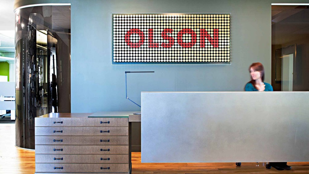 A person standing behind a desk.