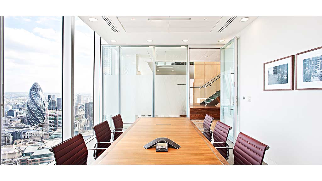 A table with chairs and a view of a city.