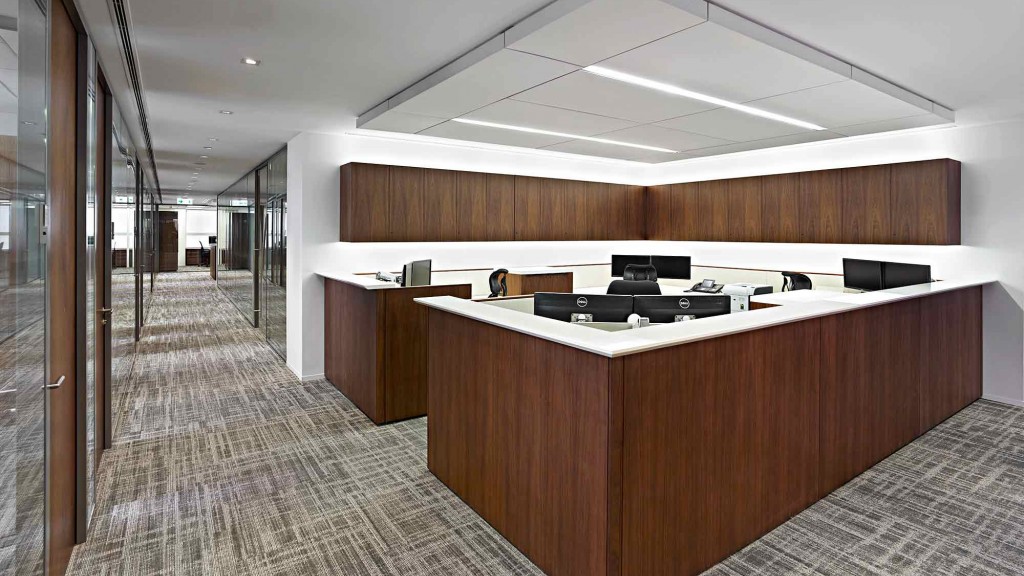 A long hallway with a counter and a glass door.
