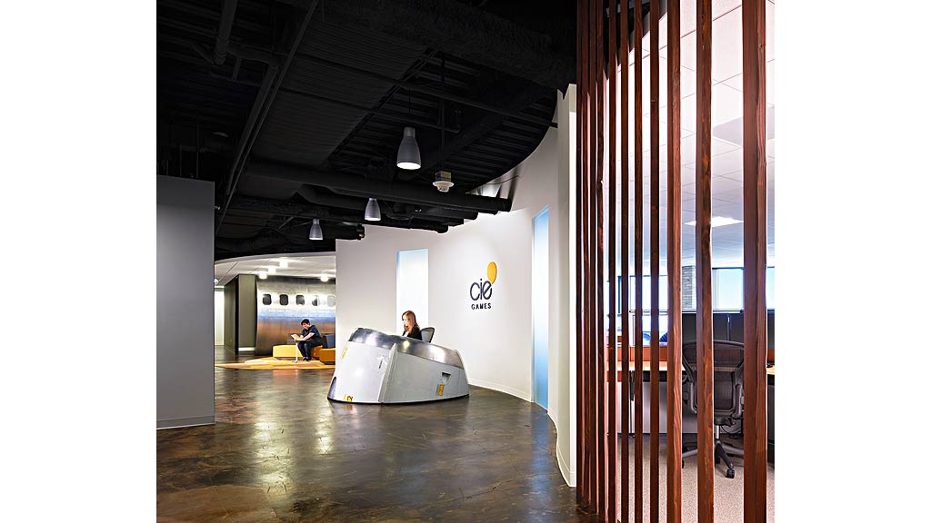 A person on a white platform in a room with a large window.