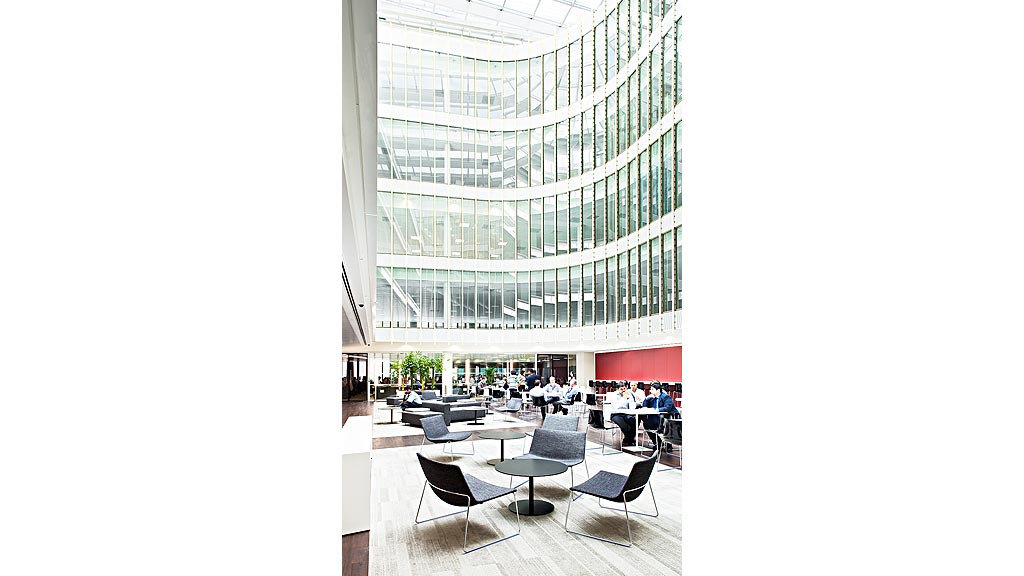 A group of people sitting at tables in a large building.