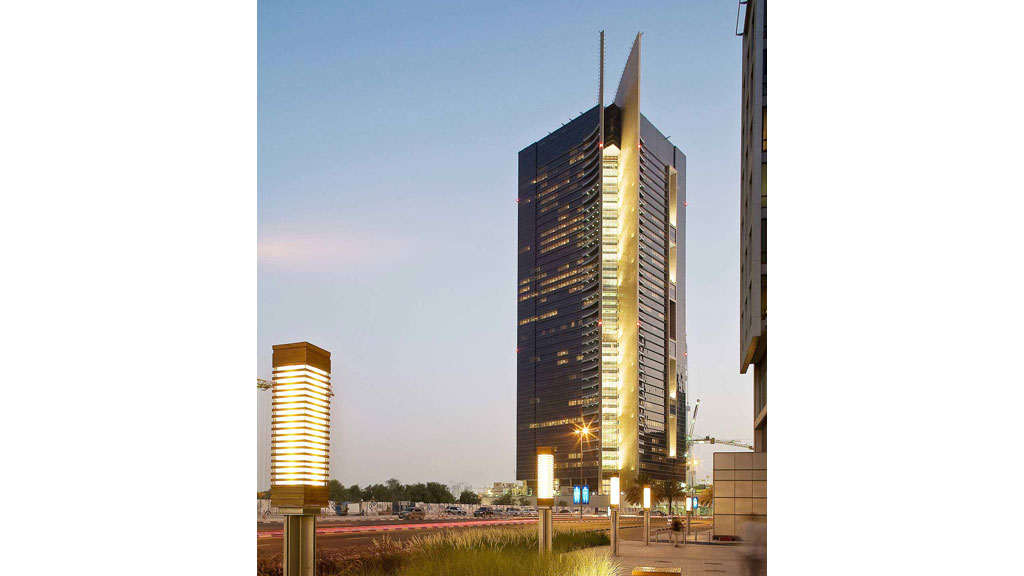 A tall building with a walkway in front of it.