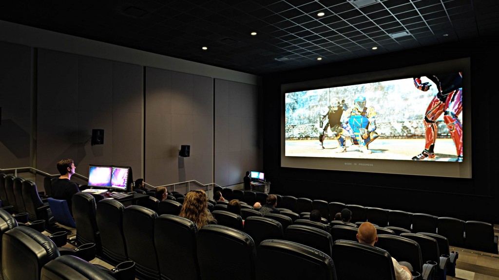 A group of people watching a presentation.