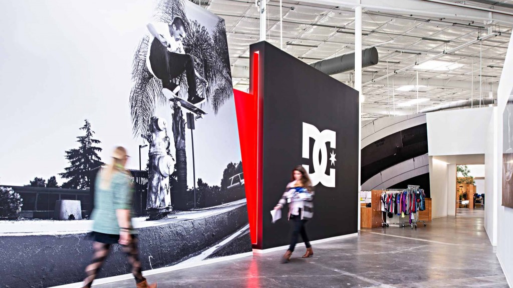 A person and a child walking in a large building.