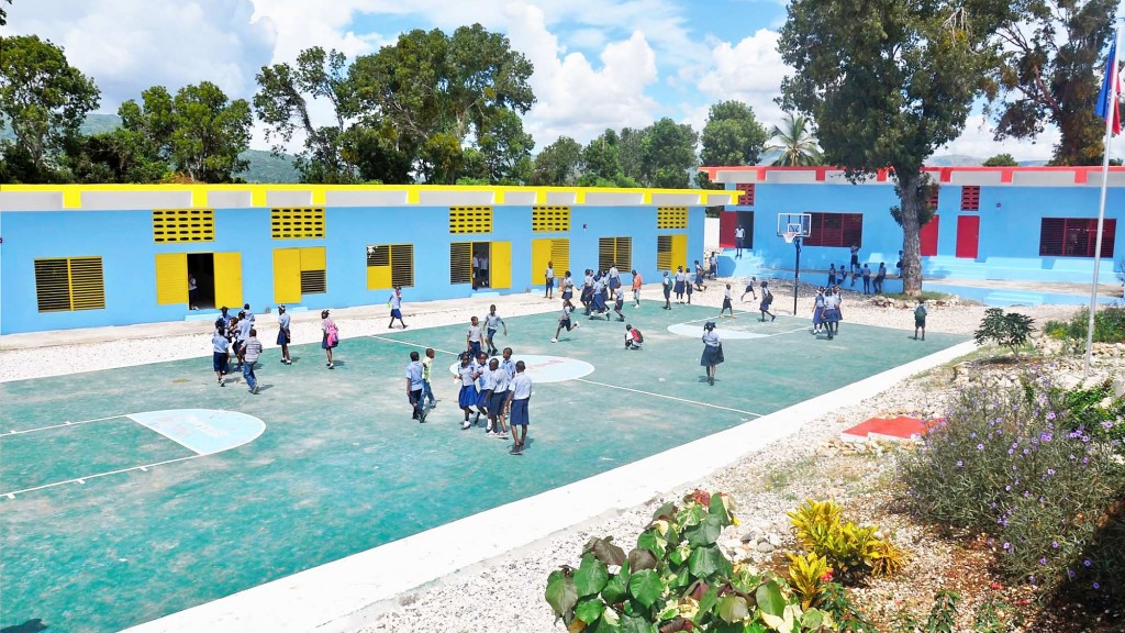 A group of people walking around a swimming pool.