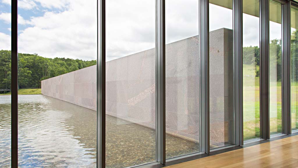 A large waterfall with glass walls.
