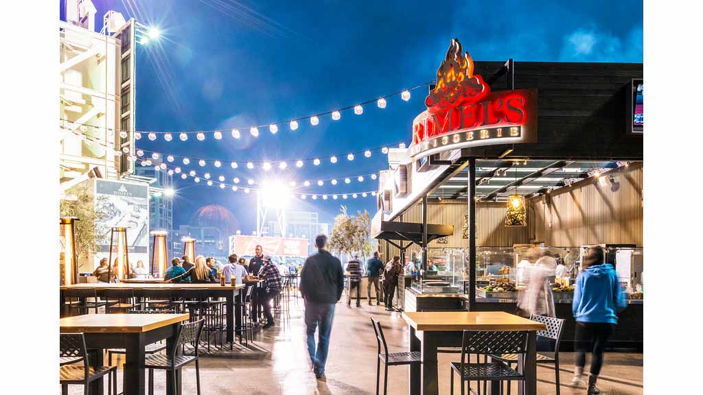 A group of people walking around a fair.
