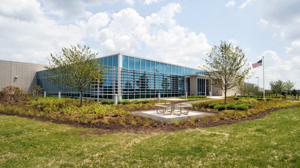 A building with a flag in front.
