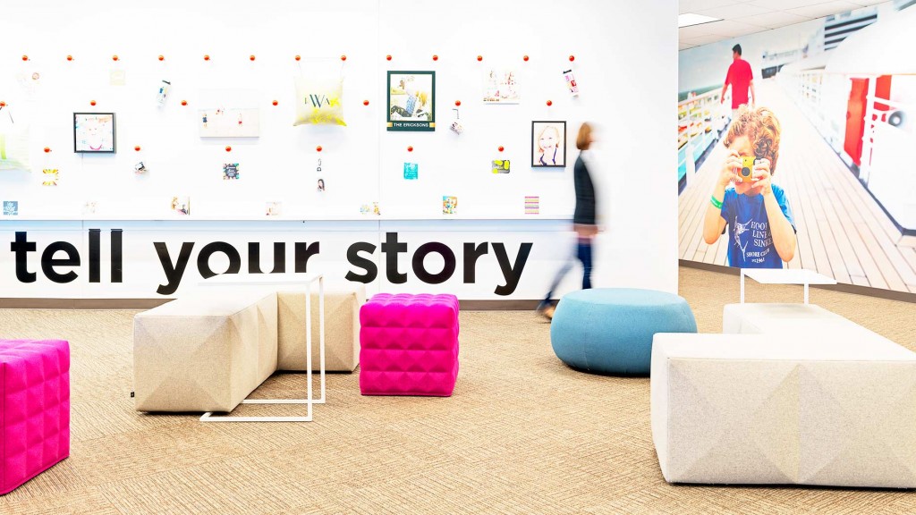 A room with a couch and a table with a sign on it.