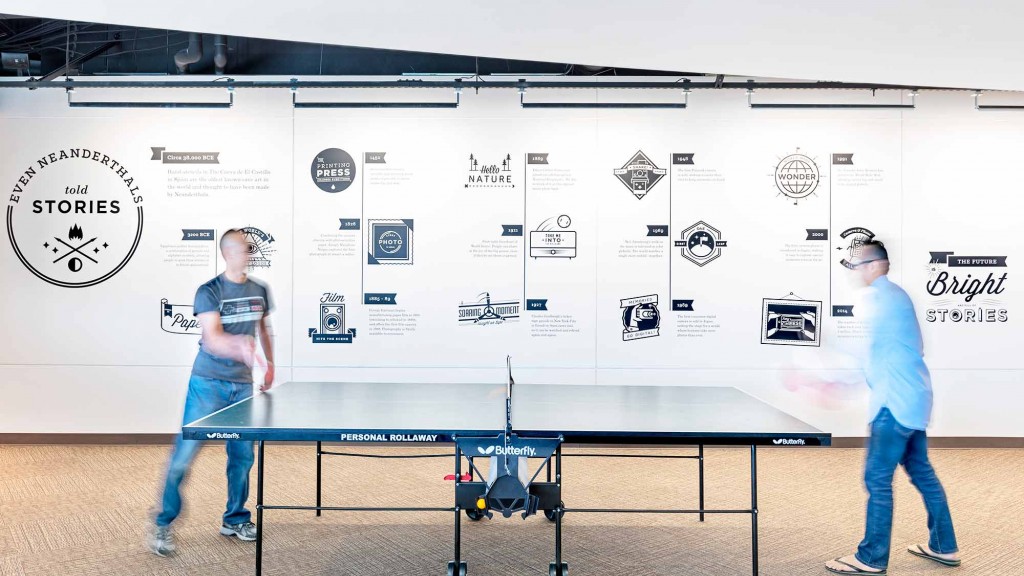 A couple of men playing ping pong.