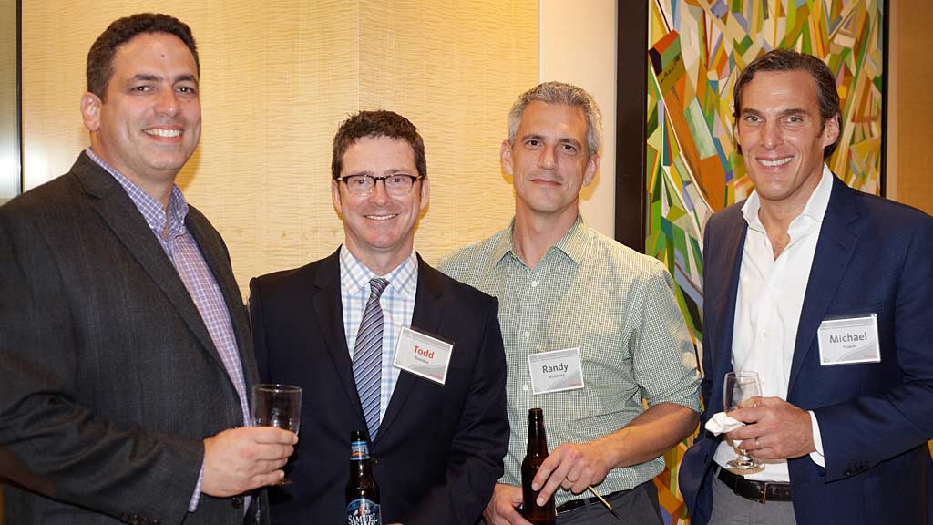 A group of men holding drinks.
