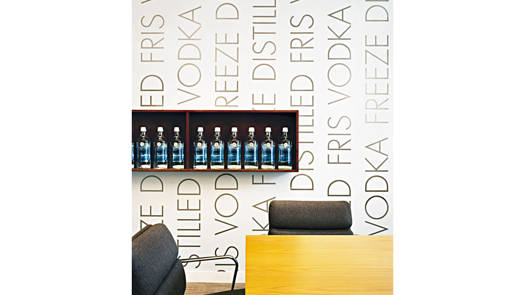 A shelf with bottles of alcohol on it.