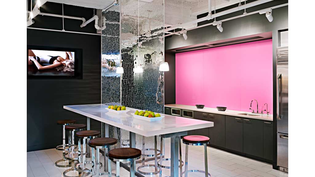 A kitchen with stools and a table.