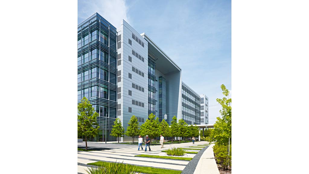 A building with a courtyard and people walking around.