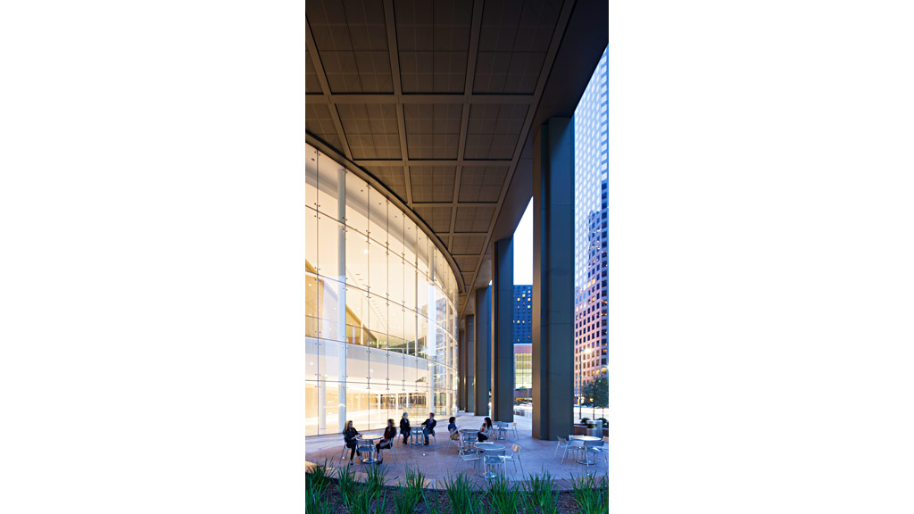 People sitting at tables in a large building.