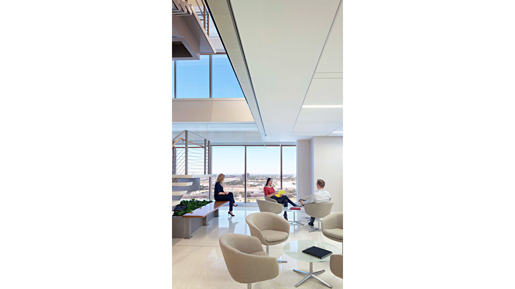 A group of people sitting in a room with a large window.