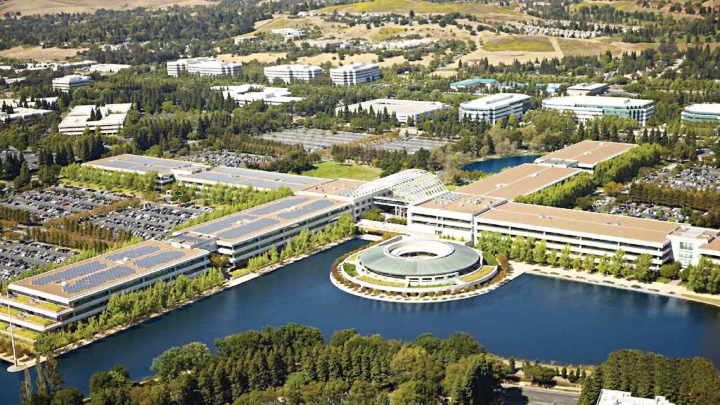 A large building with a pool in front of it.