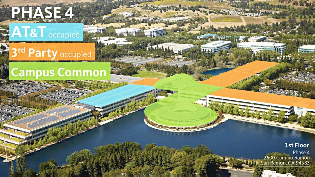 A large green field with buildings around it.