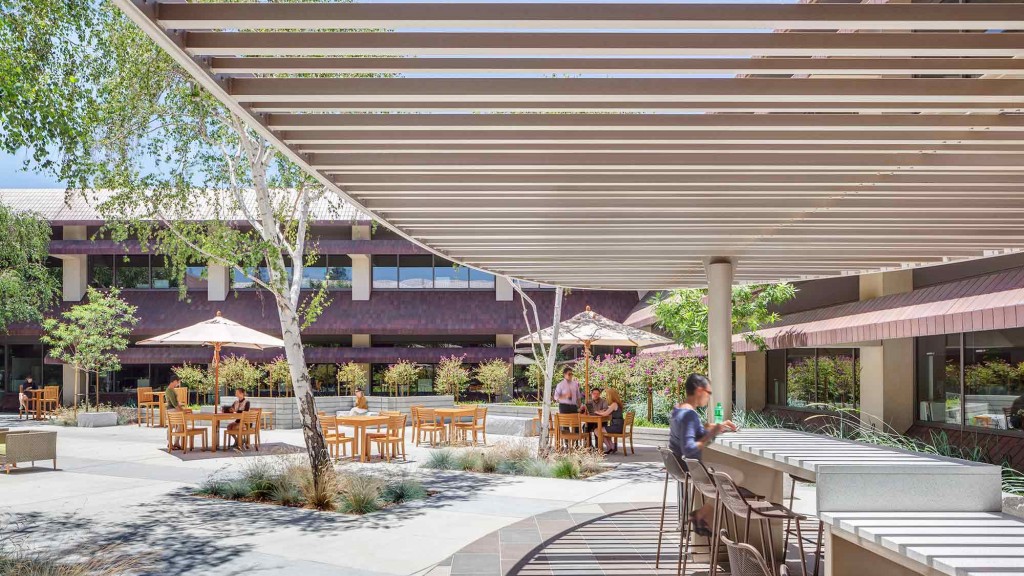 A patio with tables and chairs.