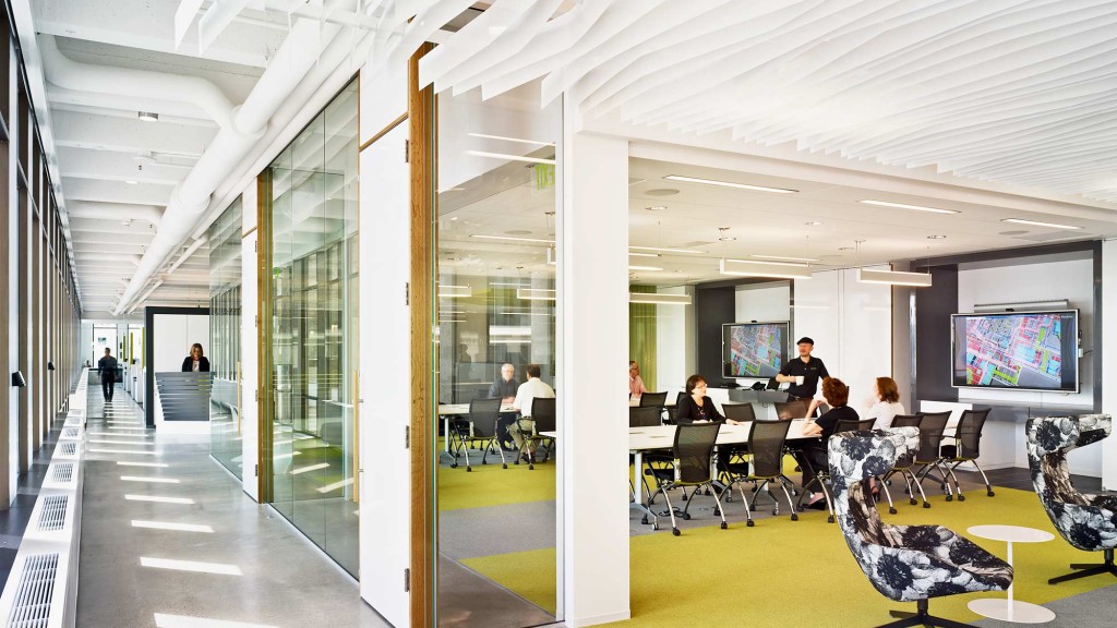 A group of people sitting at a table in a large room.