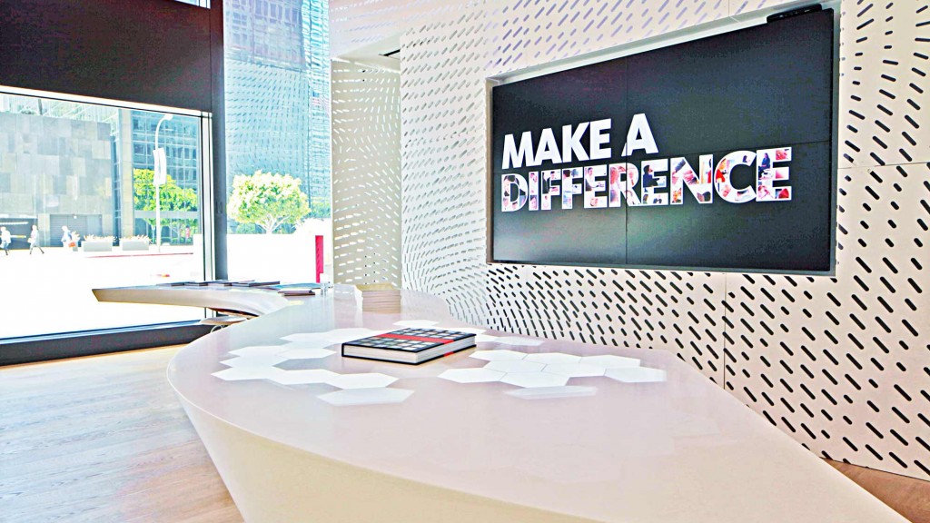 A table with a screen and books on it.