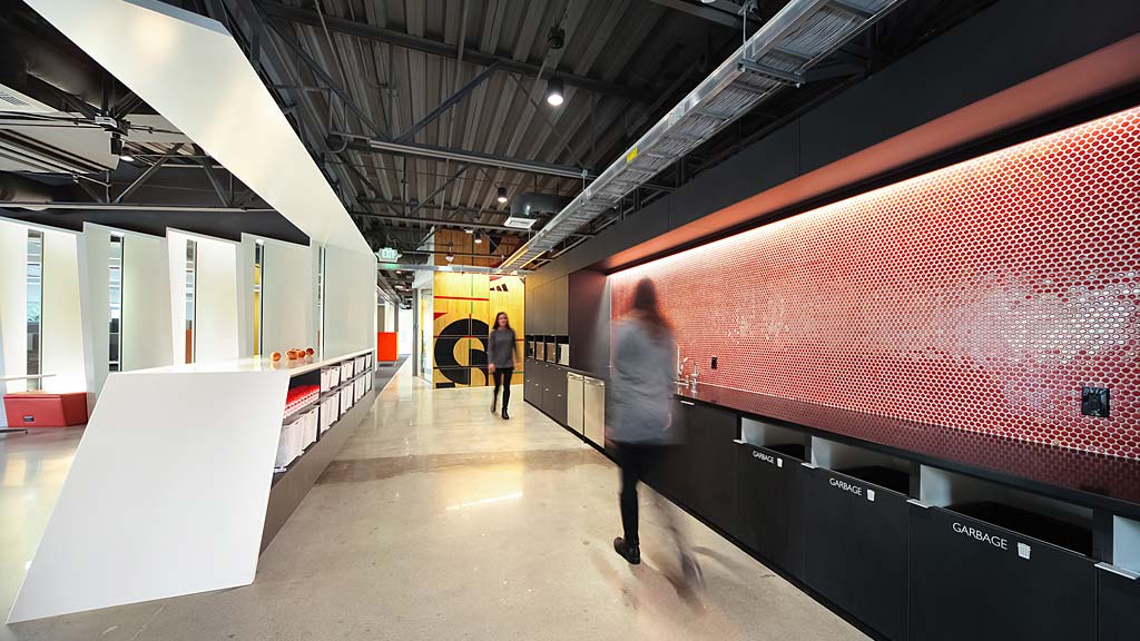 A man and a woman walking in a hallway.