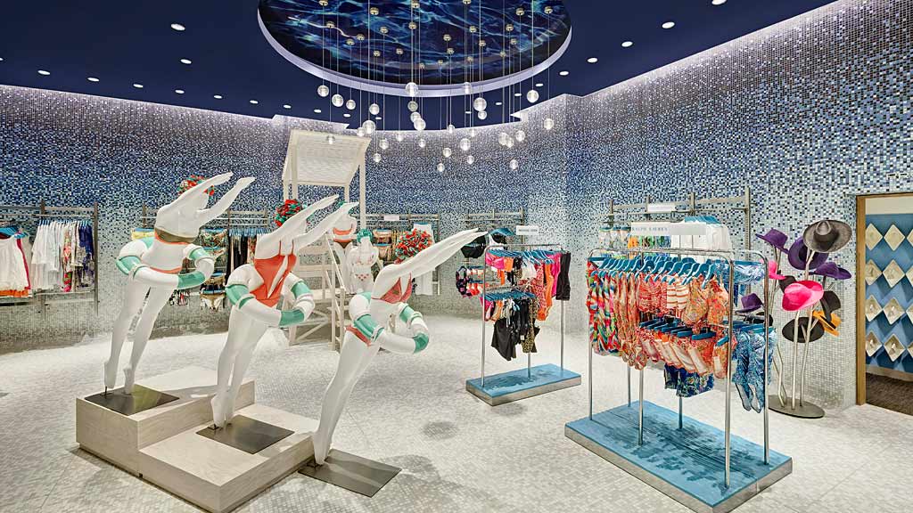 A group of white sculptures in a room with a large blue ceiling.