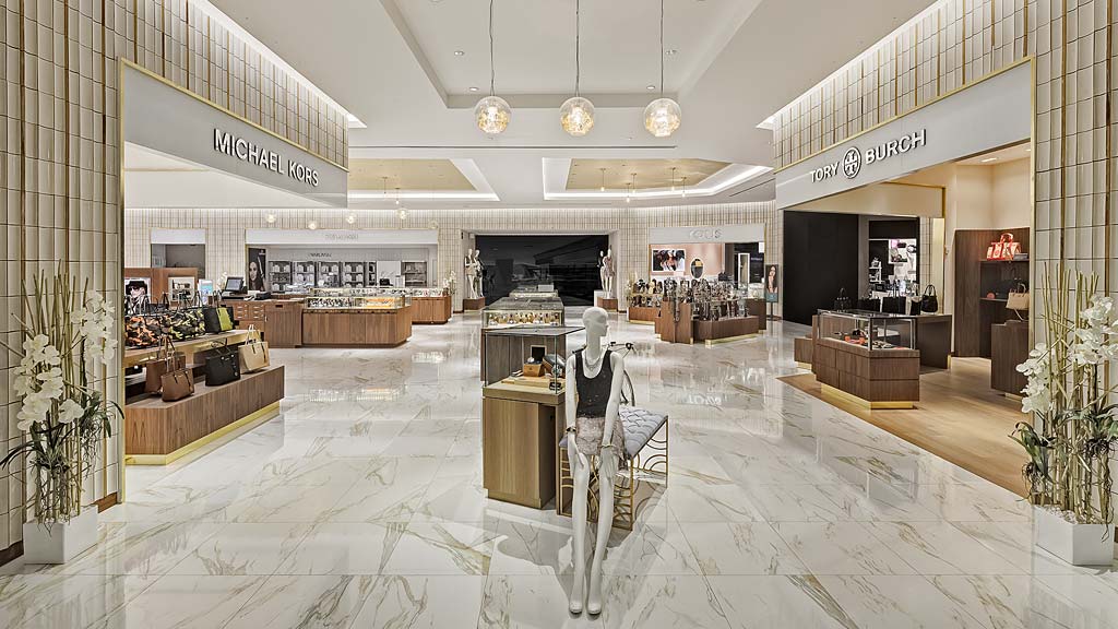 A large room with a large white floor and white chairs.