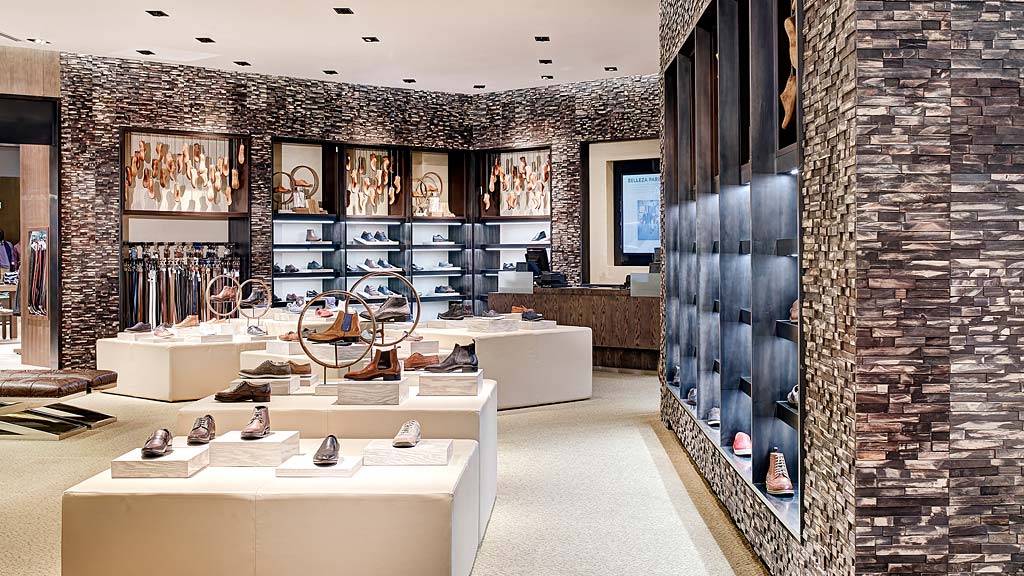 A room with a white table and chairs and a brick wall.