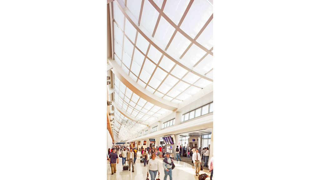 A large group of people walking inside a building.