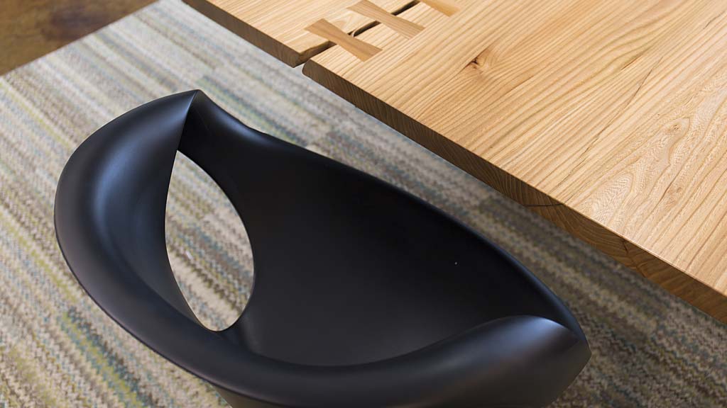 A black shoe on a wooden surface.