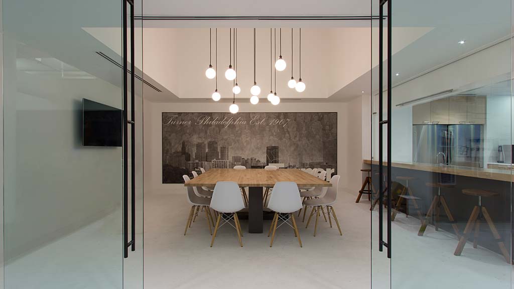 A dining room with a table and chairs.