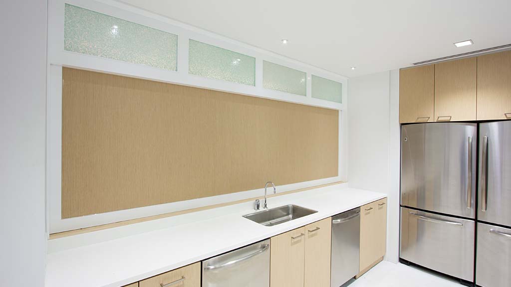 A kitchen with white cabinets.
