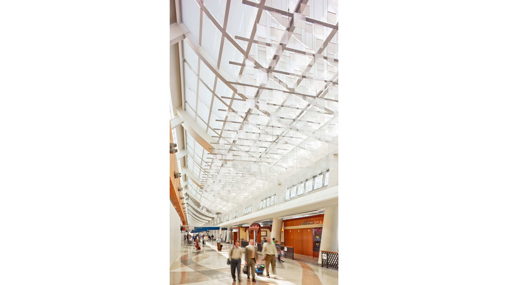 A group of people walking through a building.