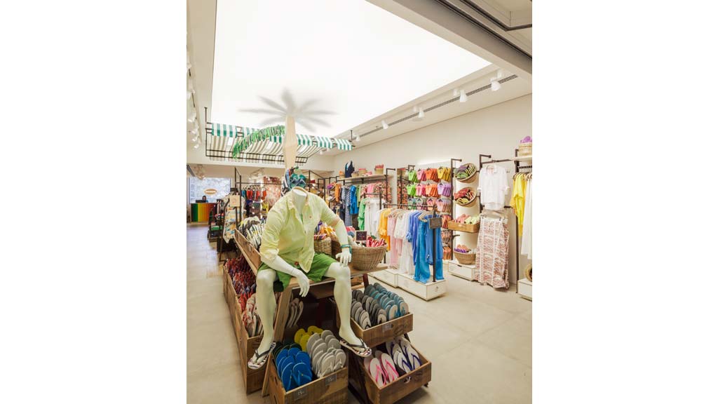 A person sitting on a bench in a store.