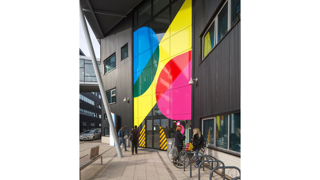A rainbow painted on a building.