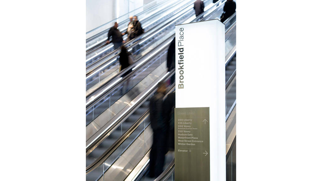 A group of people on a escalator.