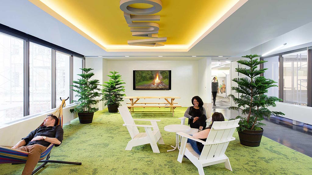 A group of people sitting in chairs in a room with a large window.