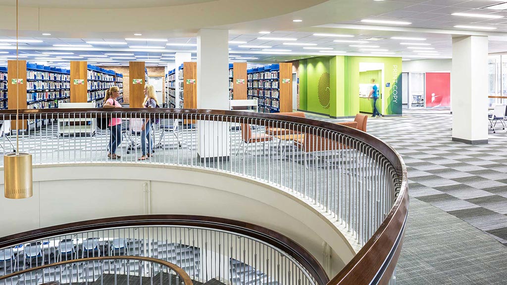 A large library with a few people.