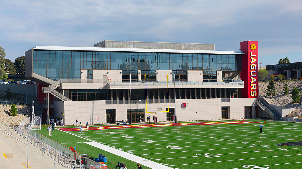 A large stadium with people in the front.