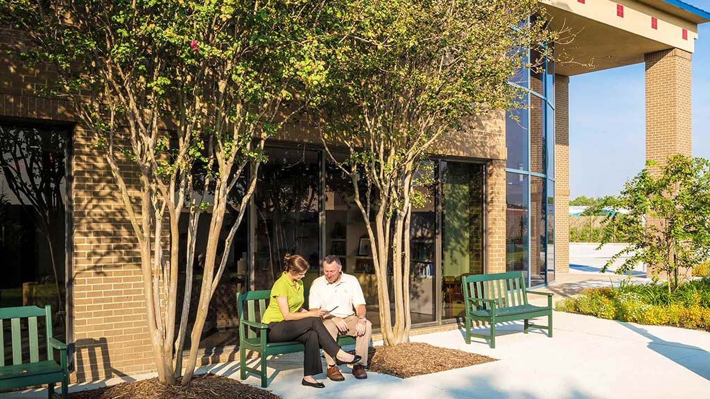 A couple sitting on a bench.