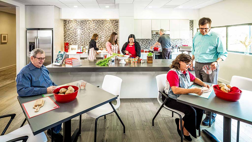 A group of people in a kitchen.