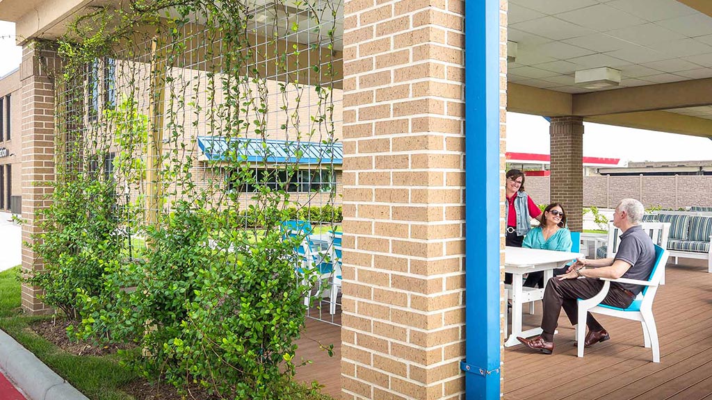 A group of people sitting at a table outside.