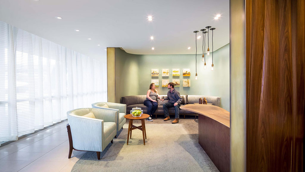 A family sitting on a couch.